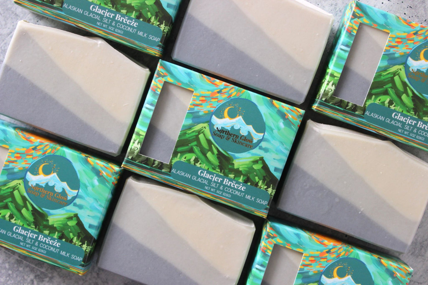 Nine bars of Glacier Breeze soap are stacked together. Some soaps are in boxes, others are not.