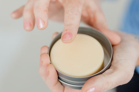 Jojoba oil and shea butter lotion bars in a tin canister.