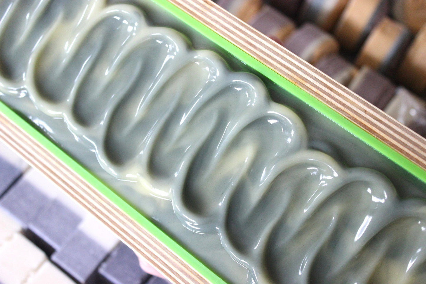 Lavender and sage goat milk soap in a wooden mold.