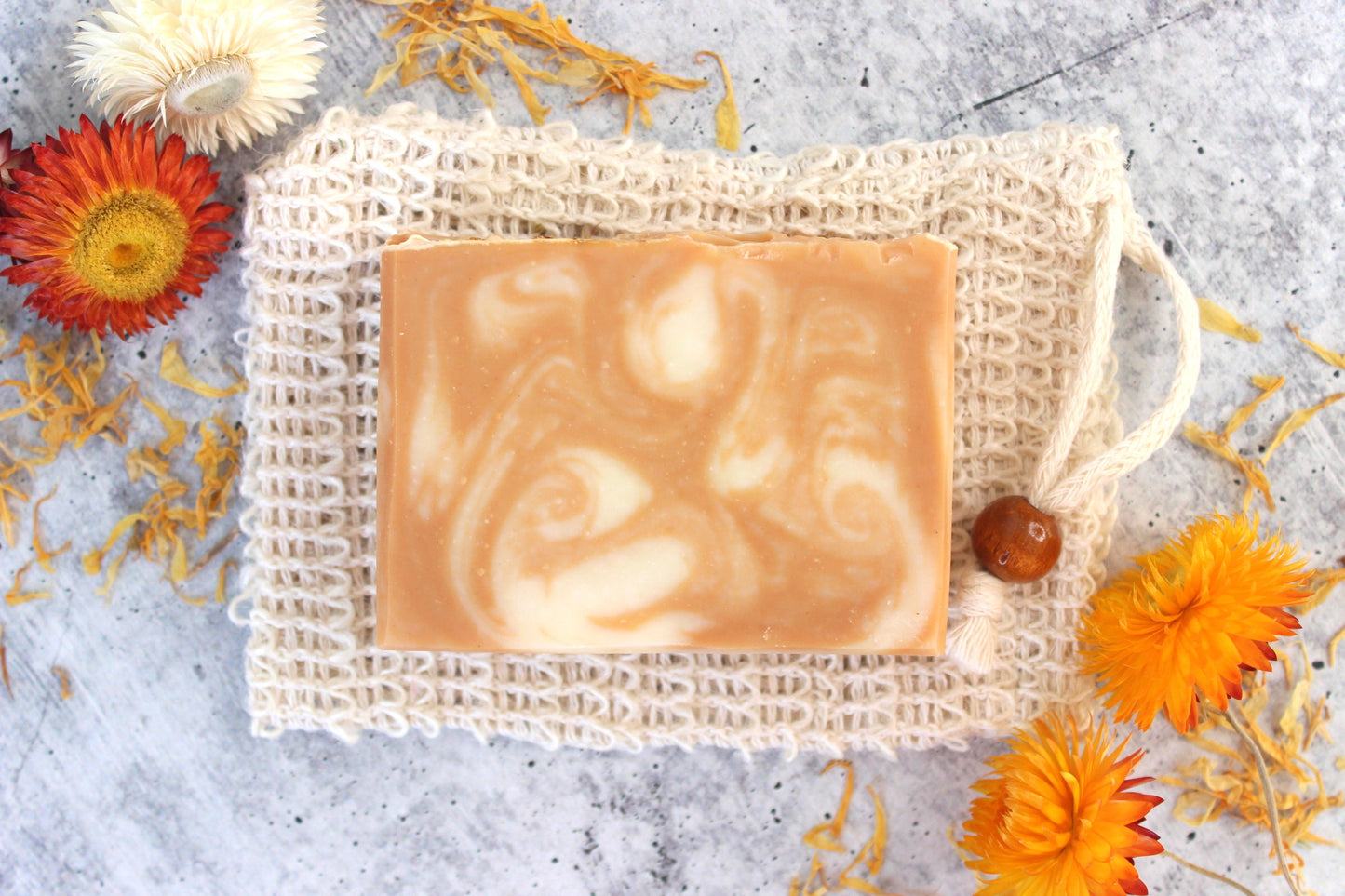 Mild soap for dry skin on a cambric soap saver bag with dried floral.