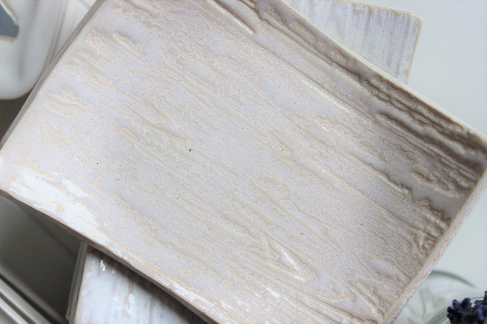 Cream colored ceramic soap dish.  Wood grain looking.