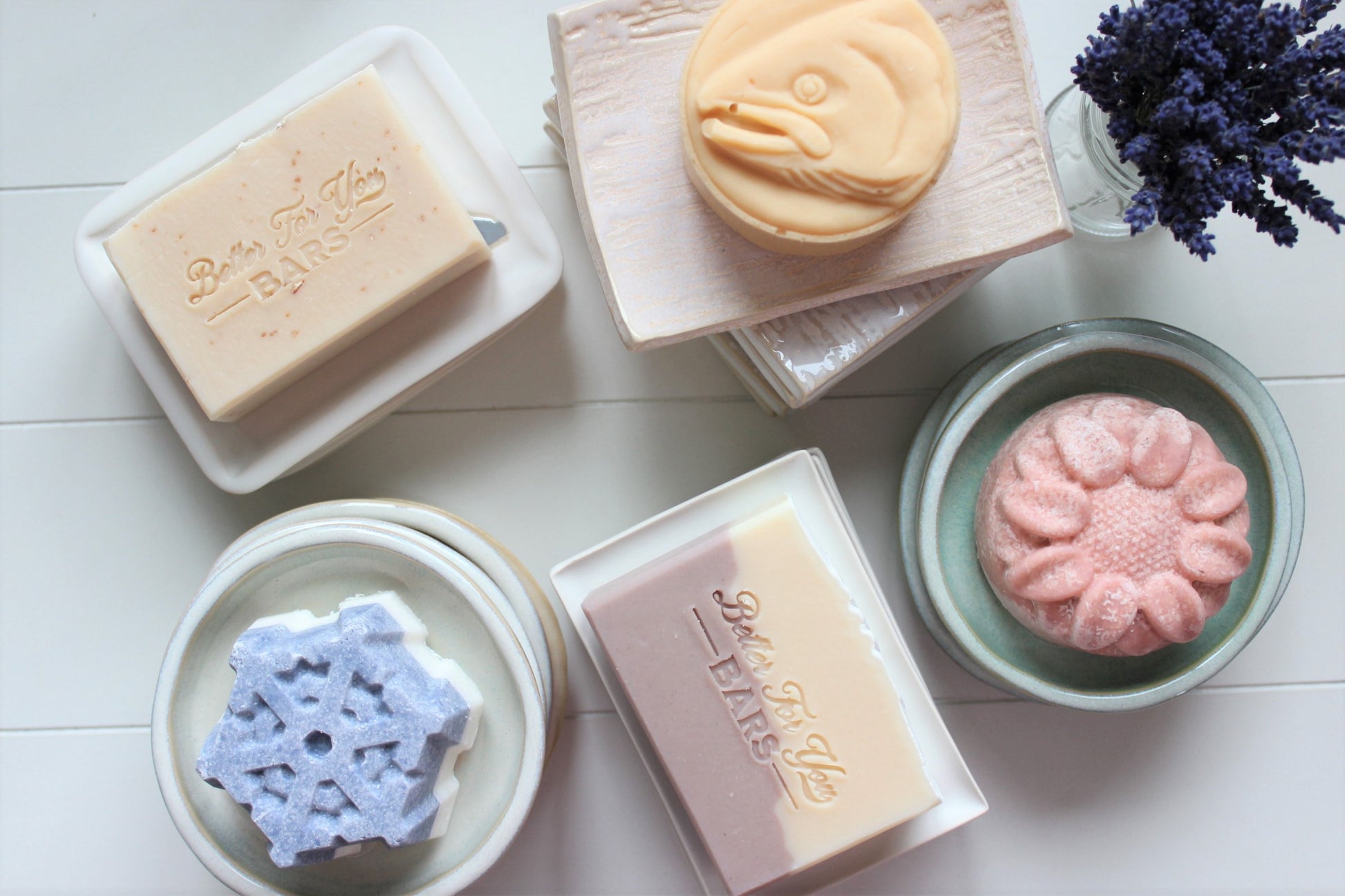 Better For You Bars natural soaps sitting on ceramic handmade soap dishes.
