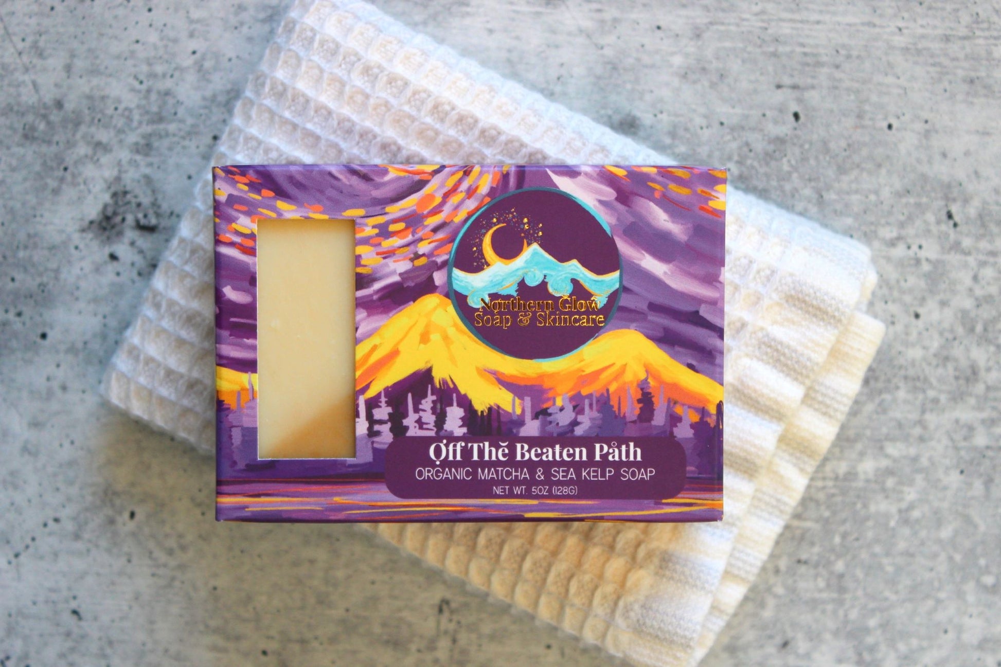 A purple box on a white washcloth.
