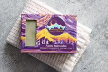 Load image into Gallery viewer, Bergamot soap in a purple box, sitting on a white washcloth.
