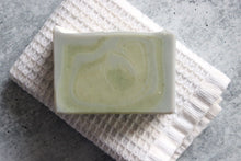 Load image into Gallery viewer, Bergamot soap on a white washcloth.
