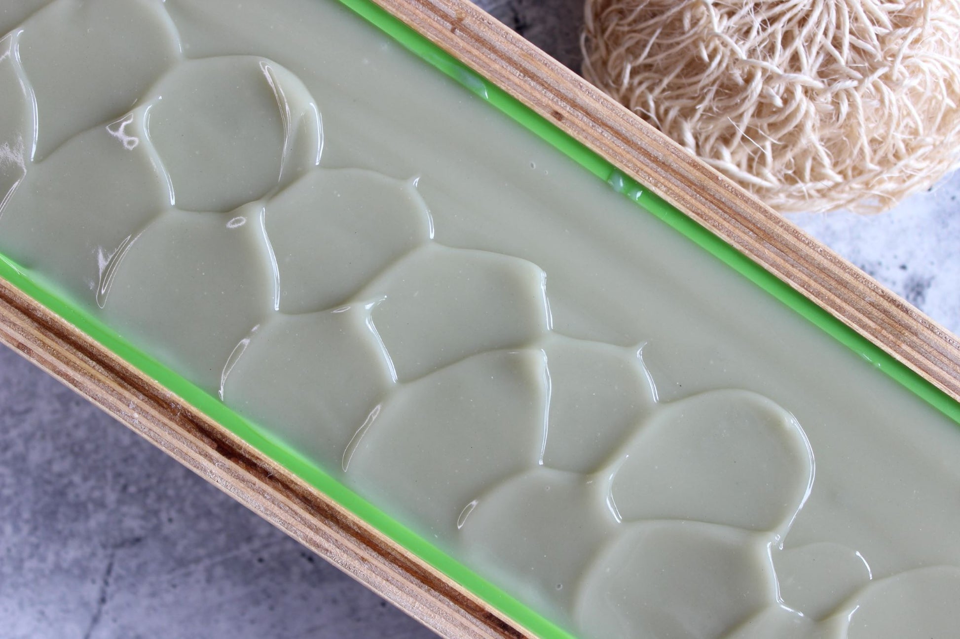 A freshly poured gray and blue soap in a wooden mold.