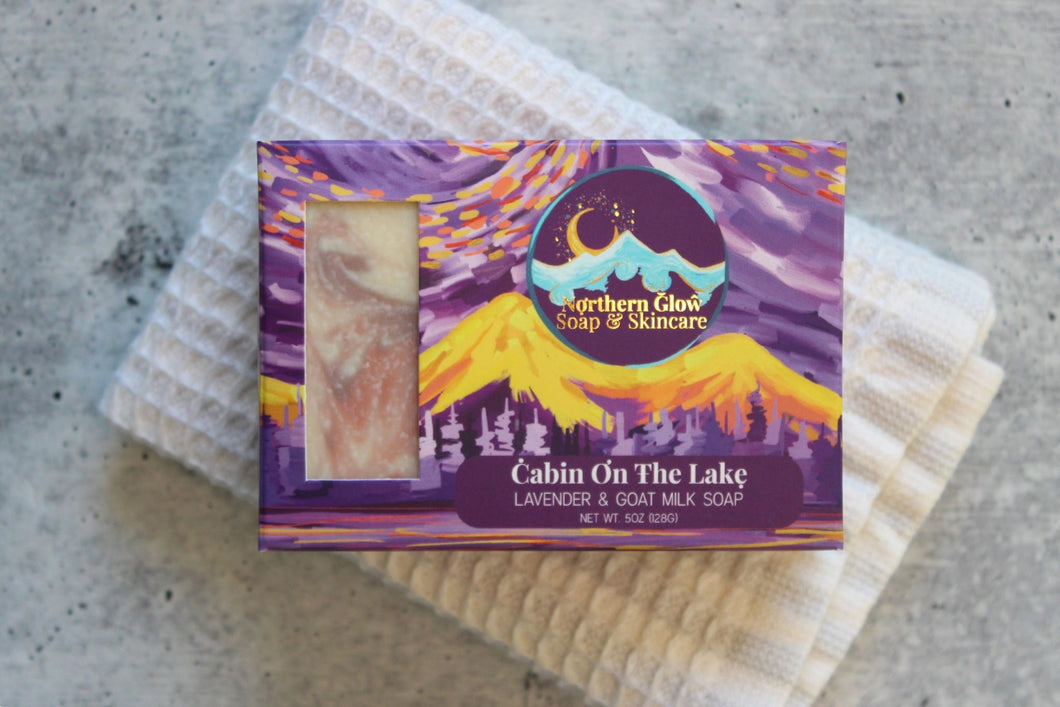 Lavender Goat Milk soap in a purple box, on a white washcloth.