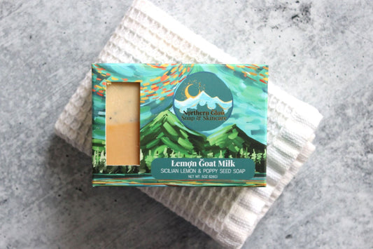 Lemon soap in a green box with mountains.