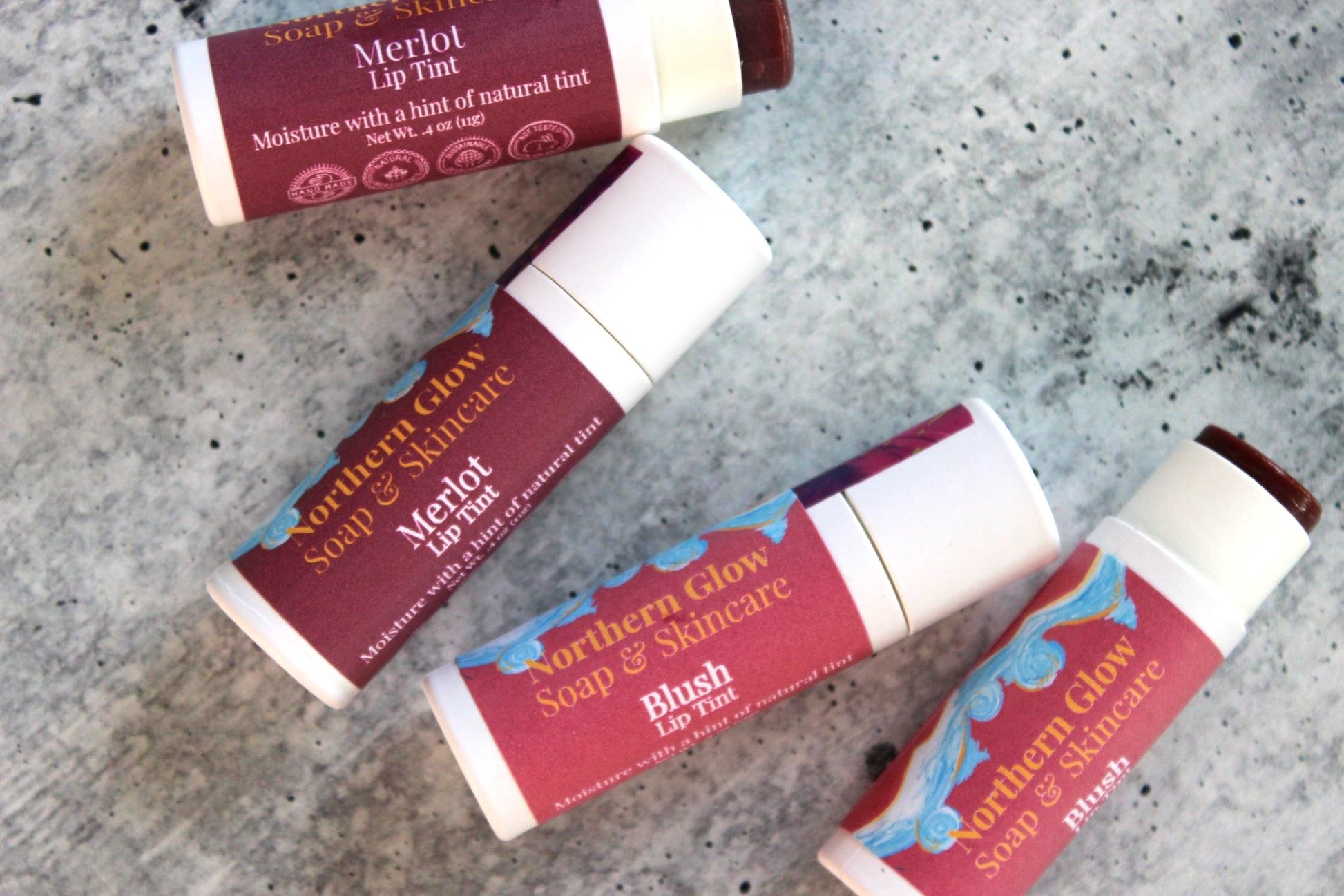 Natural Lip Tints in white paper tubes.