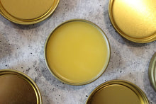 Load image into Gallery viewer, Natural salves with beeswax and seabuckthorn fruit oil in a golden tin.
