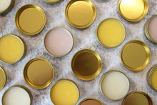 Load image into Gallery viewer, Natural salves with beeswax in golden tins.

