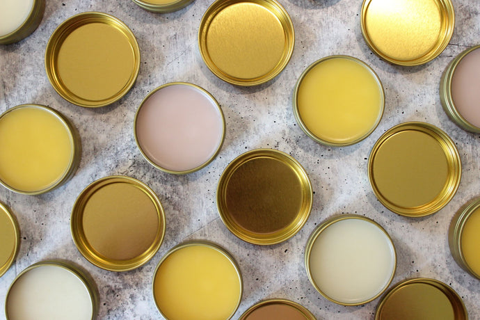 Natural salves with beeswax in golden tins.