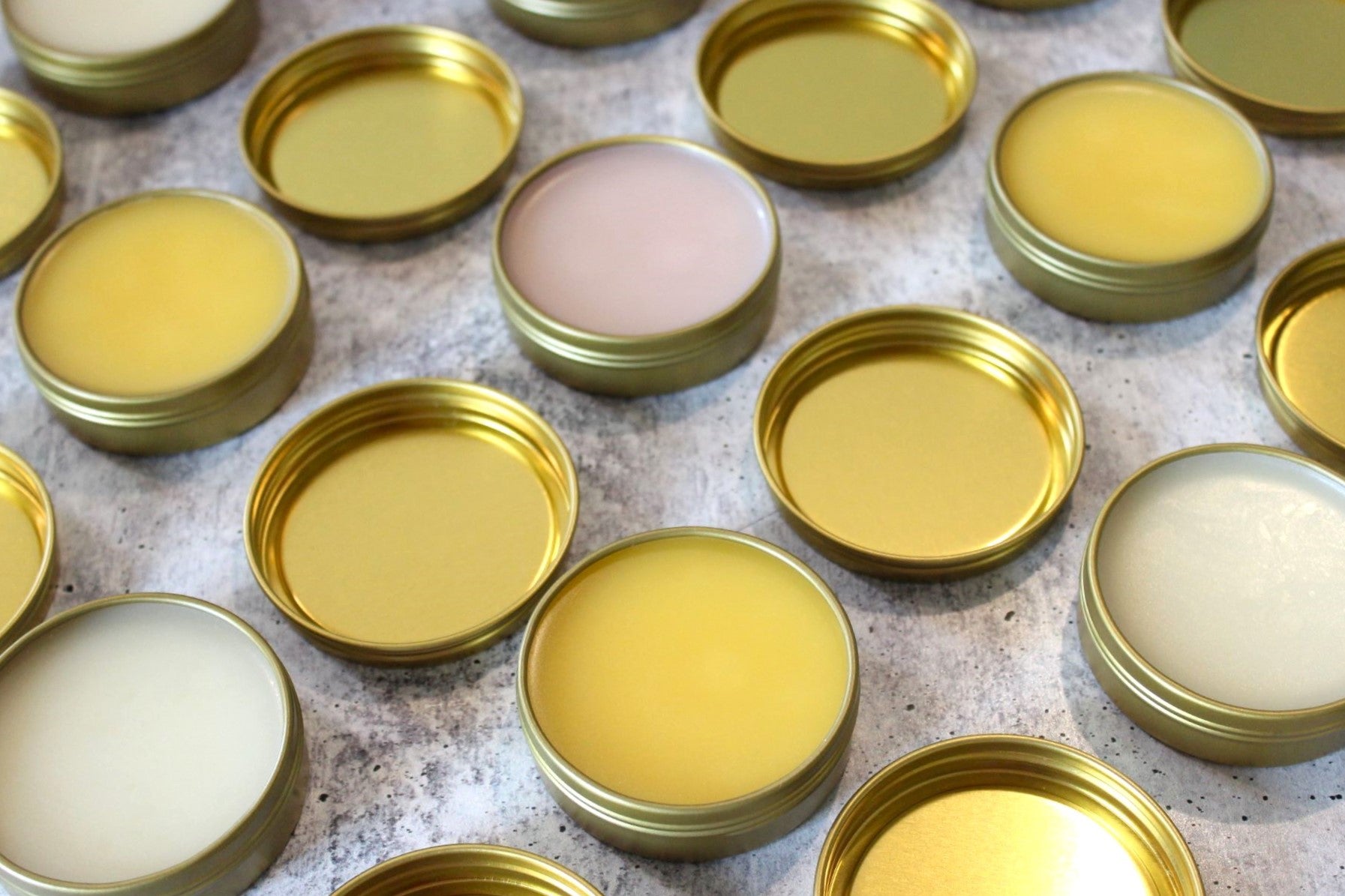 Natural salves in golden tins.