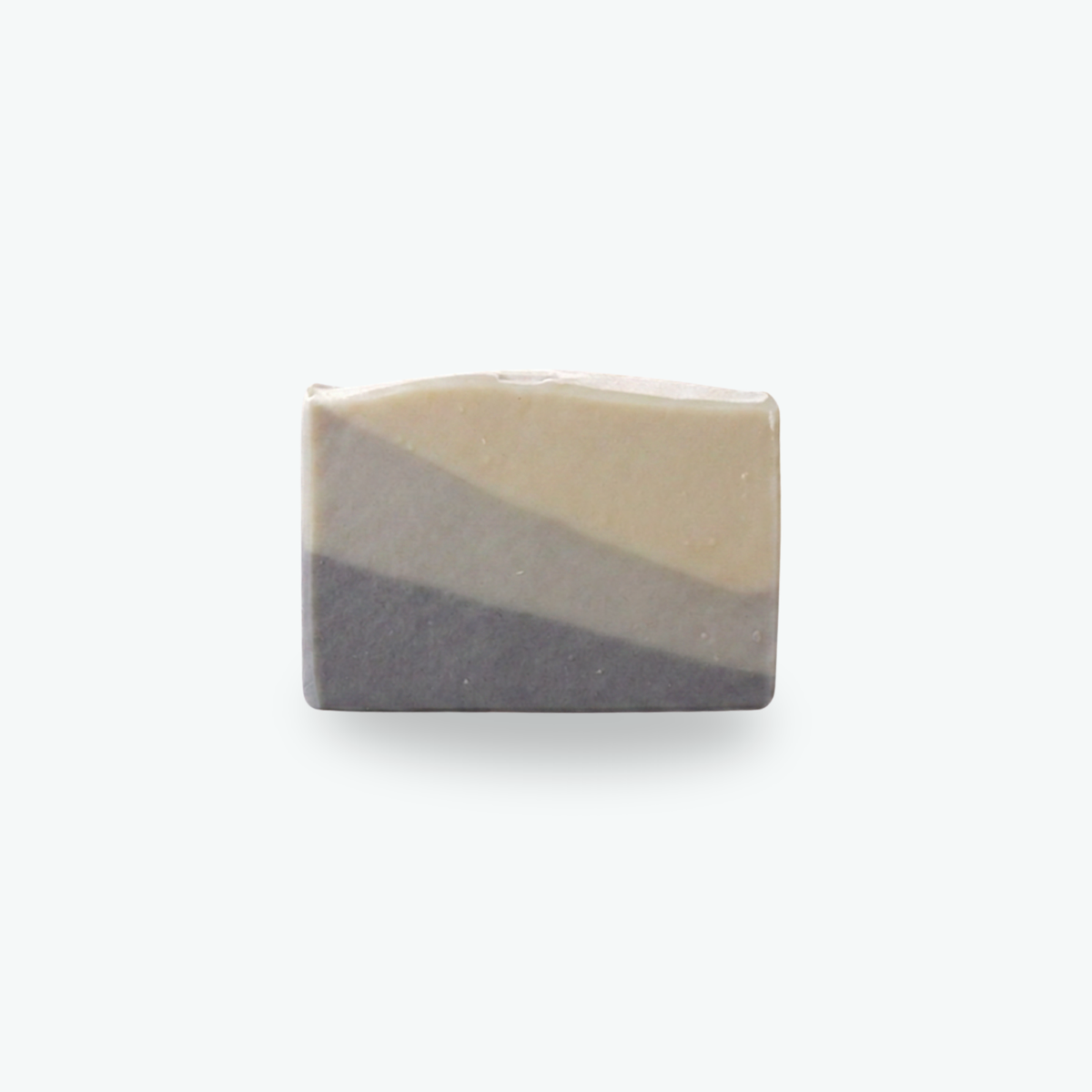 A rectangular bar of handmade soap with a diagonal color-blocked design in light gray, and dark charcoal gray, centered on a light gray background.
