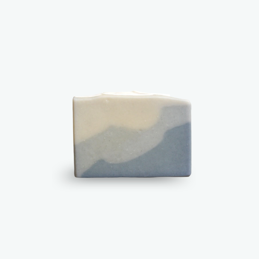 Alaska Sea Kelp Bar Soap has layers of blue ombre, darkest on the bottom, lightest on the top. Pictured on a white background.