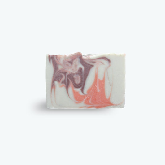 A rectangular bar of handmade soap with a white base and marbled swirls of dusty mauve-purple and coral pink, centered on a clean white background.