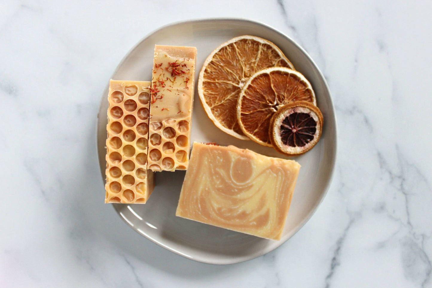 Orange and Alaska Honey Soap next to dried oranges.