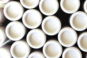 White biodegradable lip tubes clustered together.
