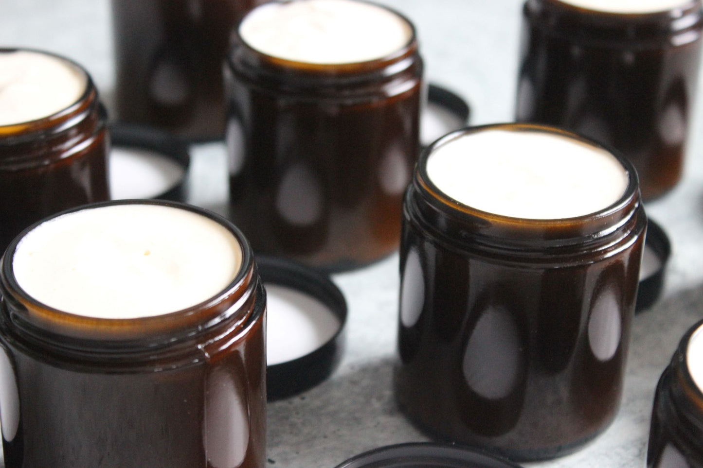 Whipped natural body butter in amber colored jars.