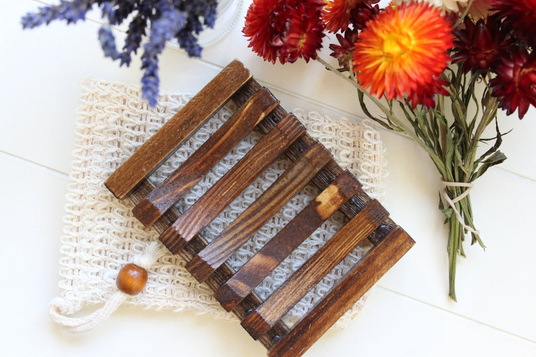 Bamboo soap dish on a cambric soap saver.  Dried flowers in background.