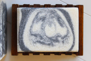 Bamboo soap dish with a handmade soap on the dish.