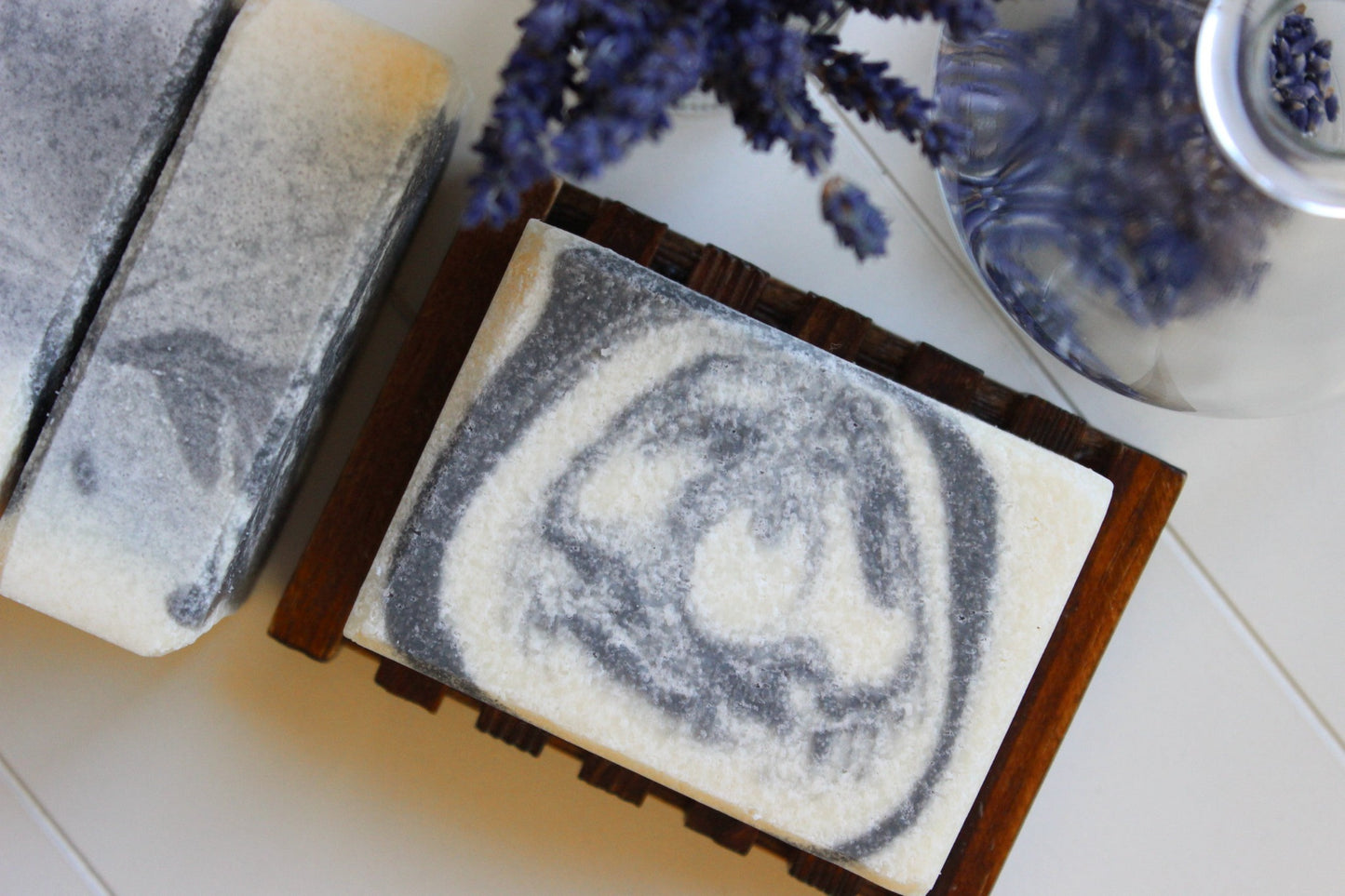 Bamboo soap dish with handmade soap.  Dried lavender in background.