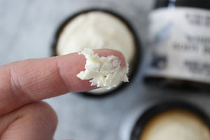 Natural Whipped Body Butter on a finger.