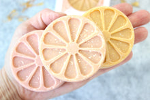 Load image into Gallery viewer, Simply The Zest soaps slices in a hand.
